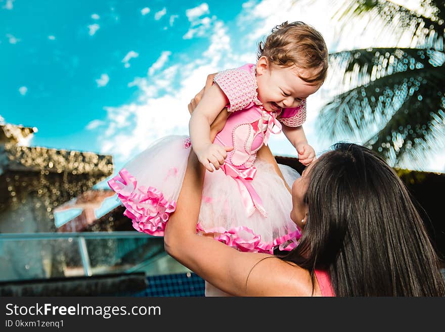 Woman Holding Baby Above Head