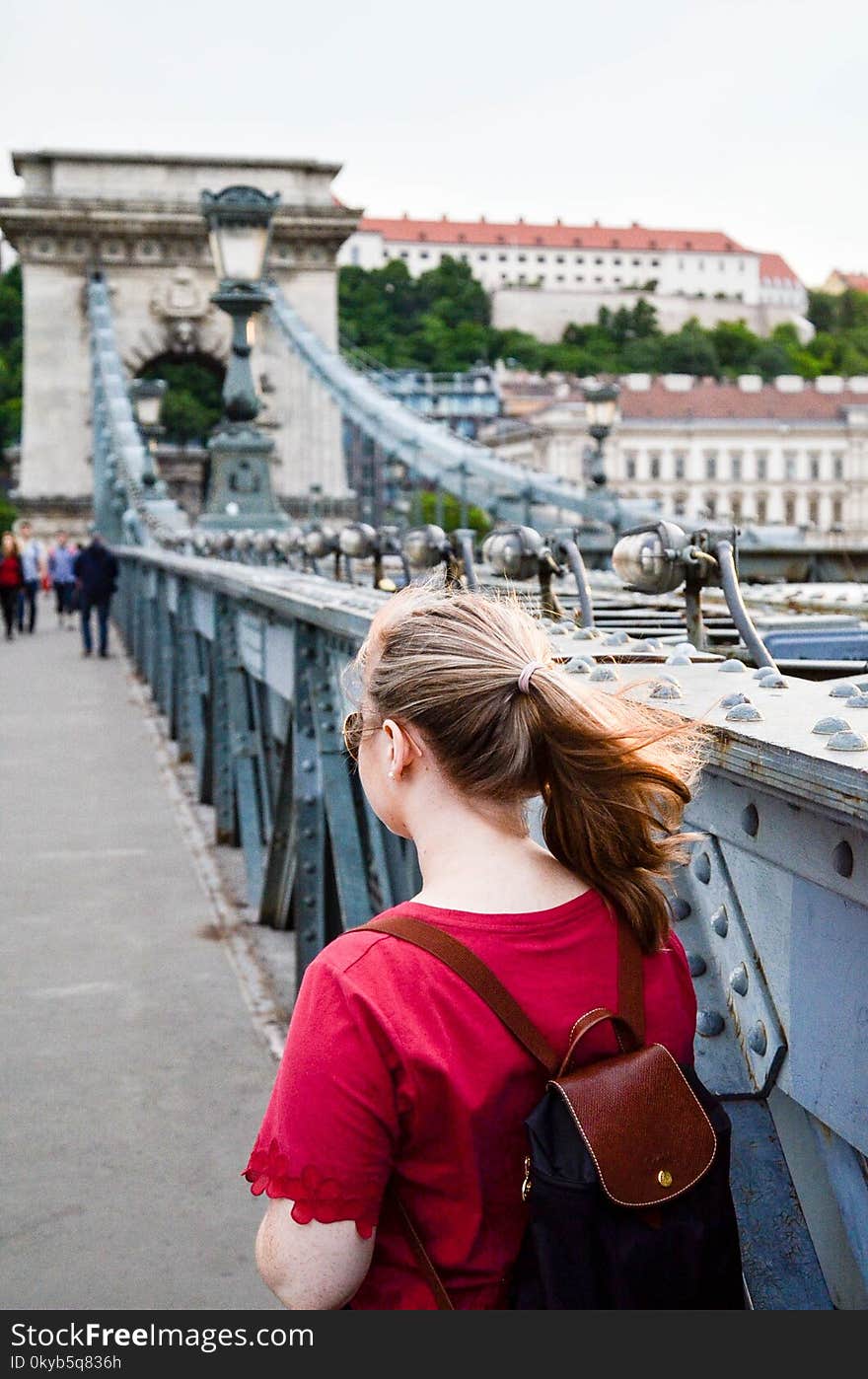 Woman Wearing Brown Leather Backpack Standing on Bridge Photo Taken