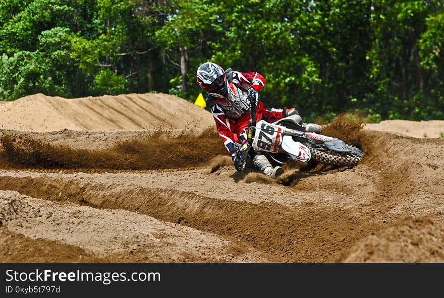 Person Driving Dirt Motorcycle on Sandy Stadium