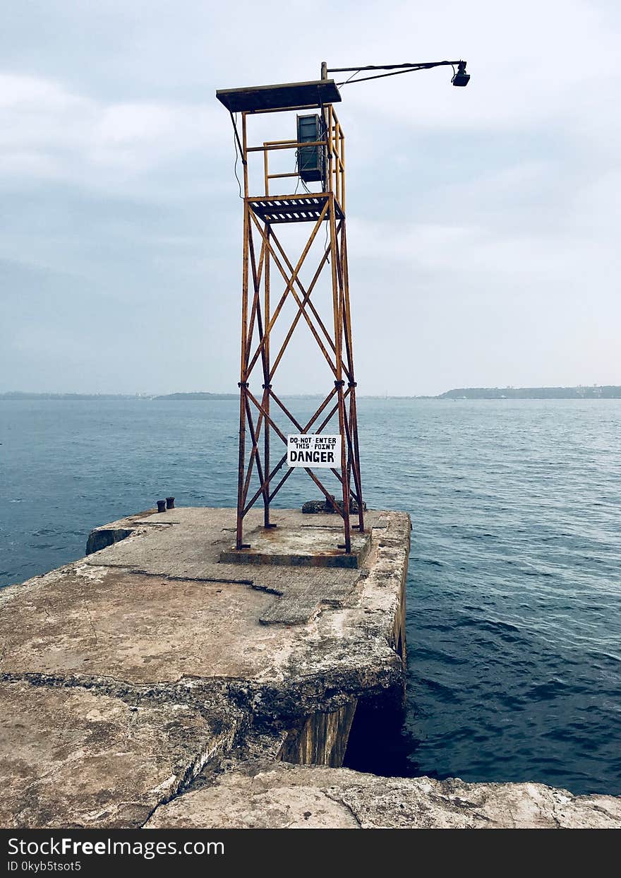 Watch Tower With Lamp Near Body of Water