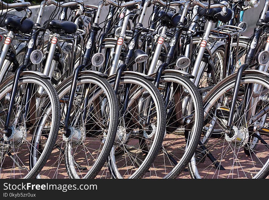 Gray and Black Bicycles Parked Near Gray Wall