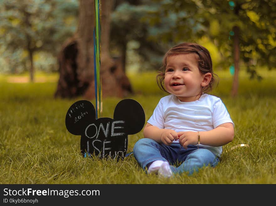 Baby Sitting on Lawn Grass