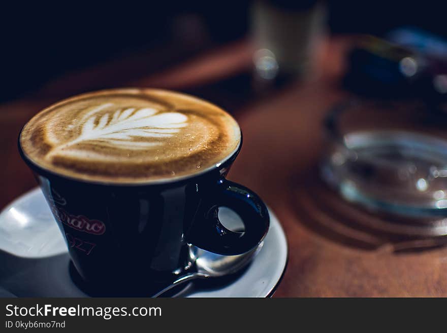 Blue Coffee Mug Near on Glass Ashtray