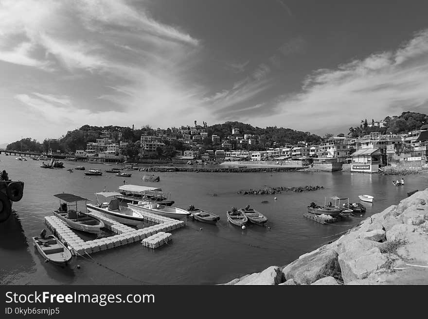 Grayscale Photography of Port Near Houses