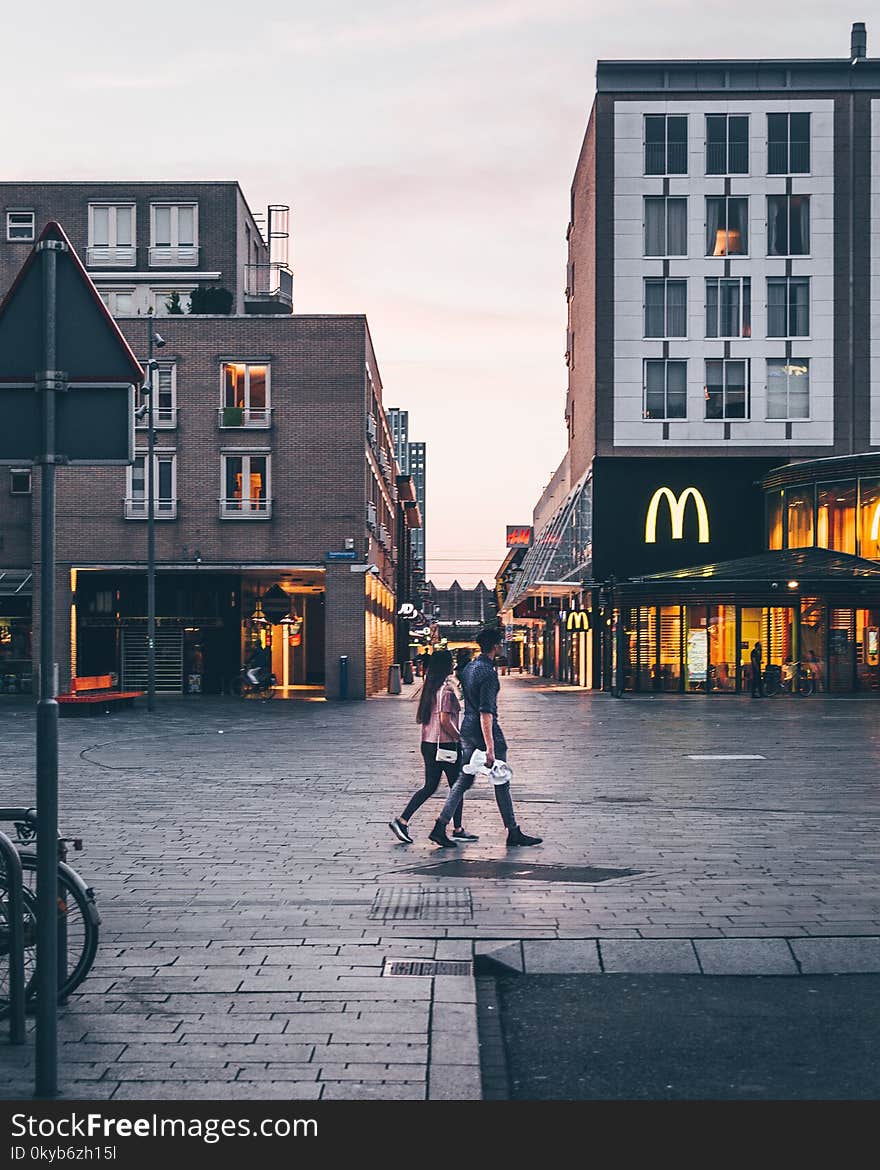 Man and Woman Walking on the Road