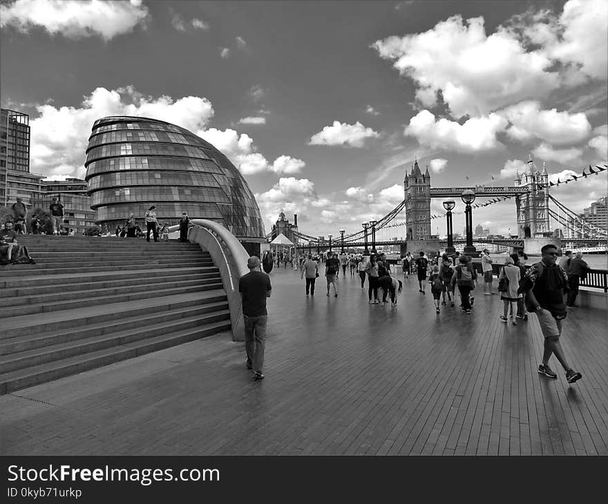 Grayscale Photo of People Walking Near Tower Bridge at London