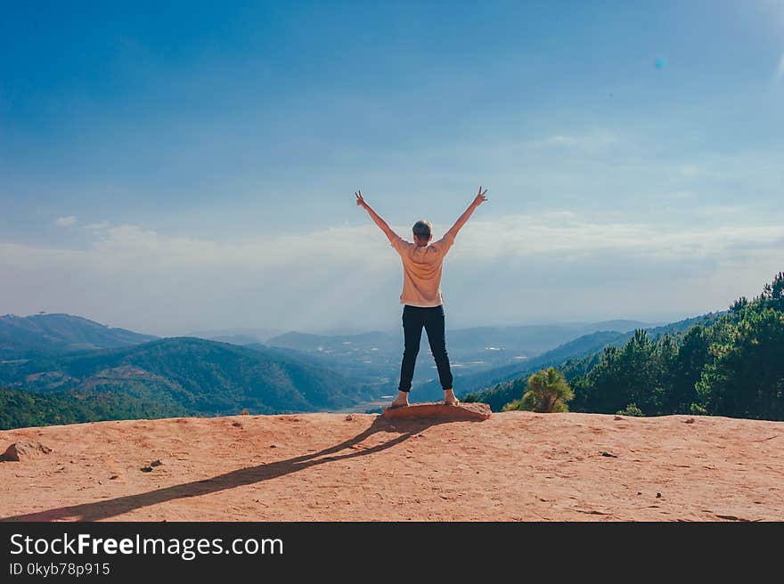 Woman Standing on Cliff