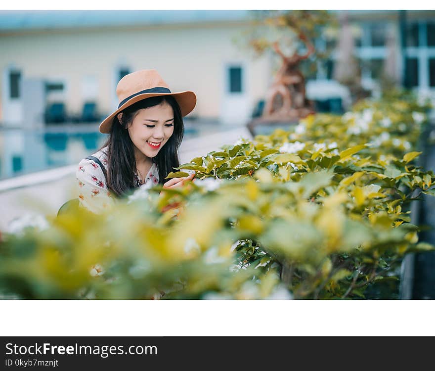 Woman Wearing Brown Hat Standing Near Plants