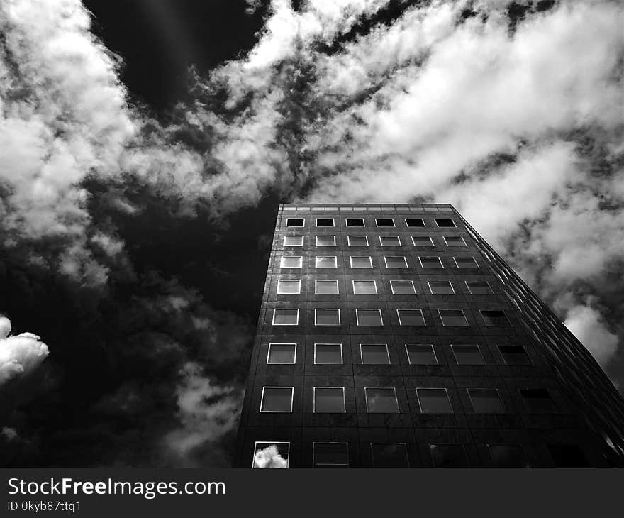 Low-angle Photography of Concrete High-rise Building Under Cloudy Skies