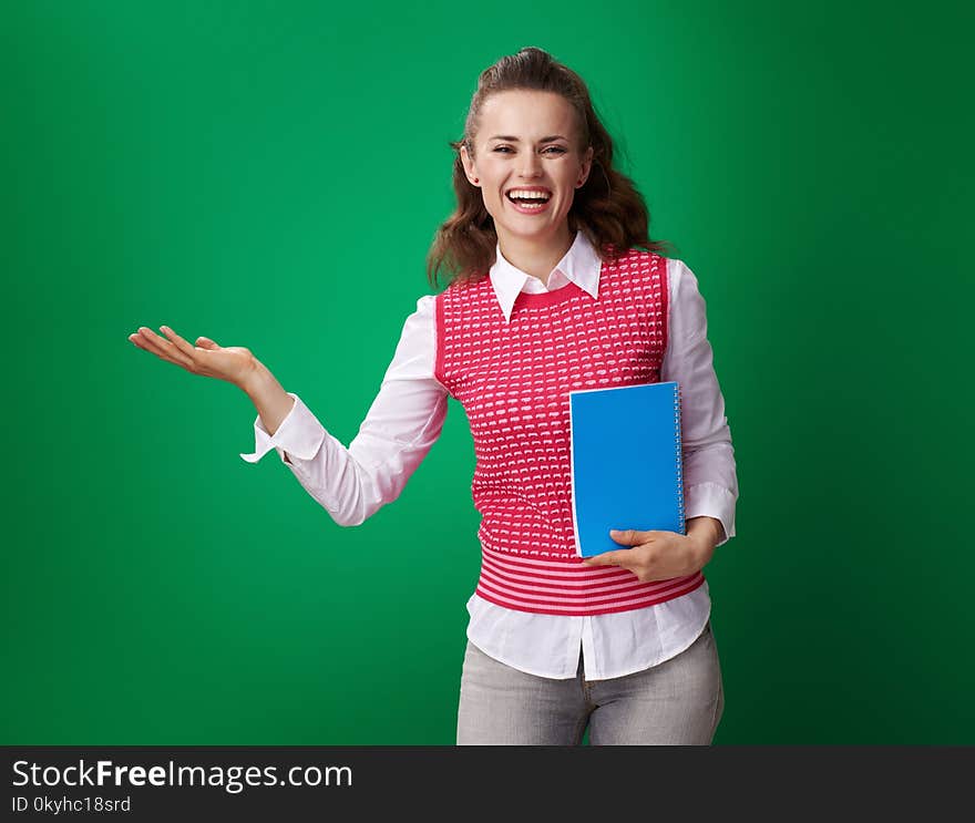 Student woman with blue notebook presenting something on empty