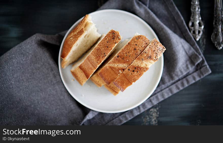 Morning breakfast table and homemade Bread in the dish. black table folk knife