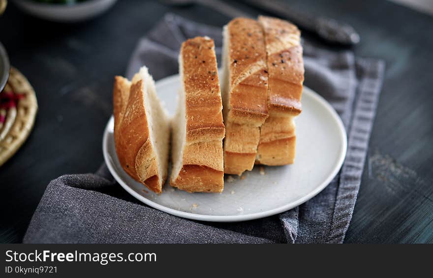 Morning breakfast table and homemade Bread in the dish. black table folk knife