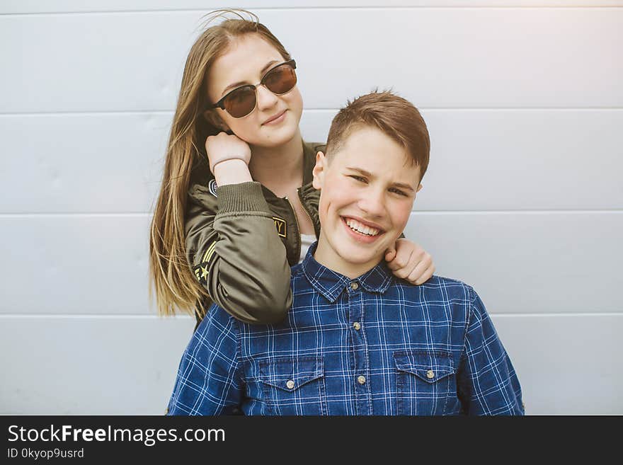 Summer holidays and teenage concept - group of smiling teenagers with skateboard hanging out outside.