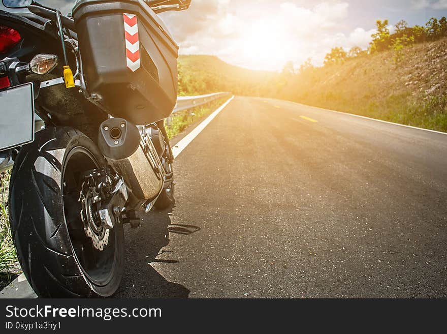 Touring motorbike on the side of the street with Warm light.