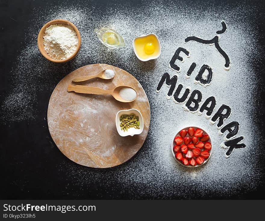 Eid Mubarak - Islamic holiday welcome phrase ` happy holiday`, greeting reserved. Strawberry open cake. Arabic cuisine background.