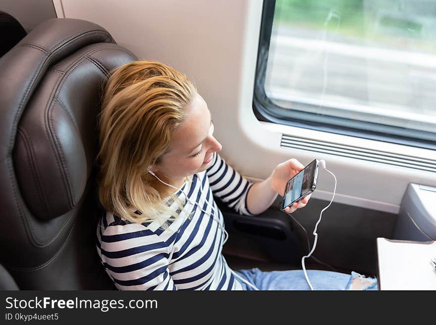 Woman Communicating On Mobile Phone While Traveling By Train.