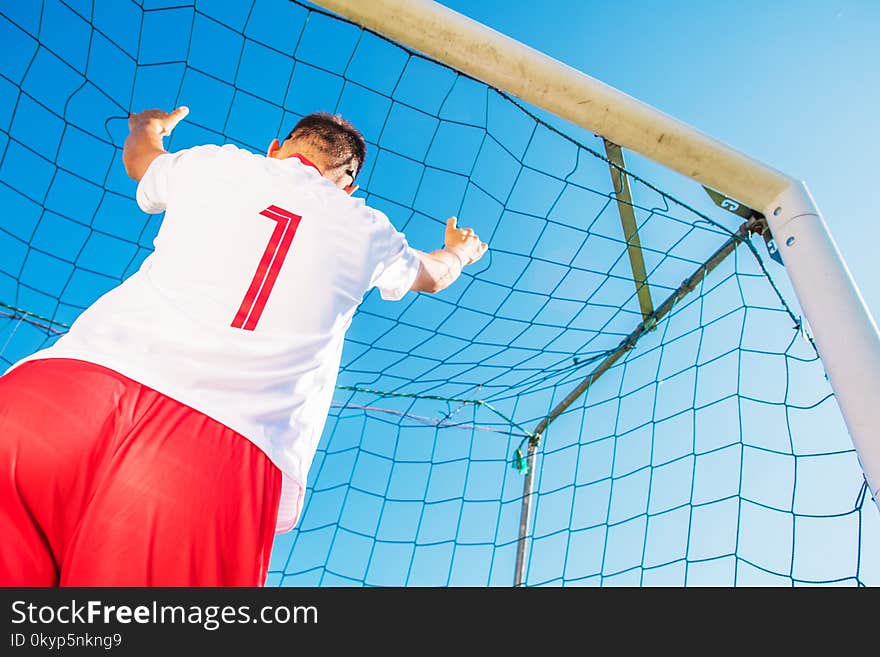 Goalkeeper with Number One on the Tshirt in the Goal. European Football Theme. Soccer Playing. Goalkeeper with Number One on the Tshirt in the Goal. European Football Theme. Soccer Playing.