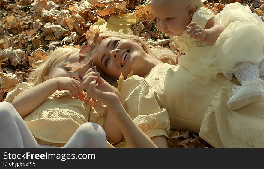 Happy family mother and children in autumn park