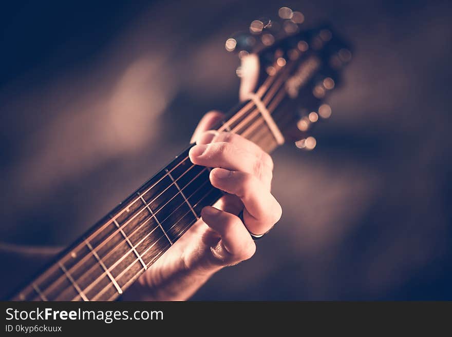 Learning Acoustic Guitar. Hands on the String Instrument Closeup Photo.