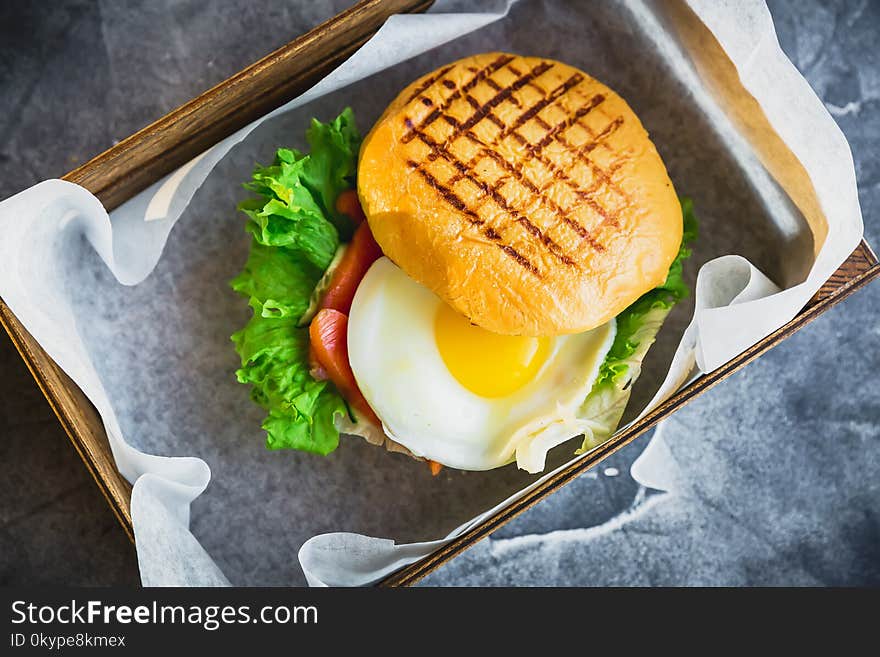 Hamburgers with egg, lettuce and salmon fish. Tasty food