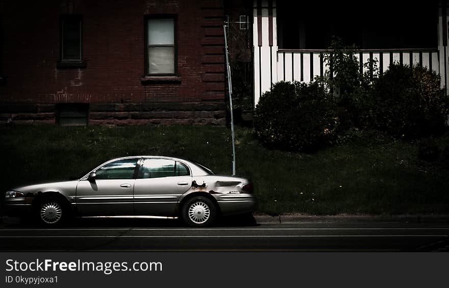 Car parked on the street against two apartment buildings