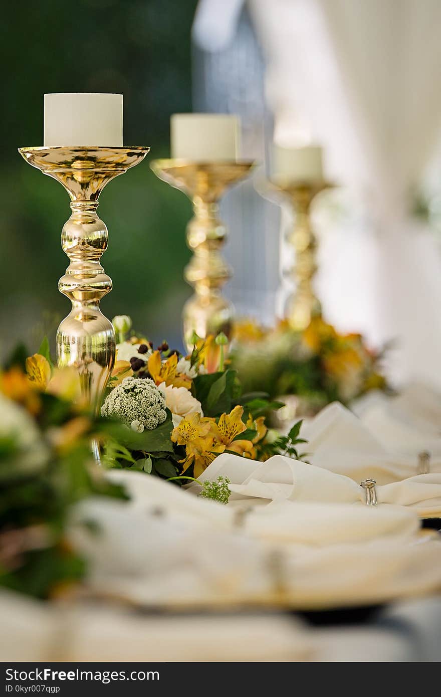 Selective Focus Photography of Gold Candlestick on Table