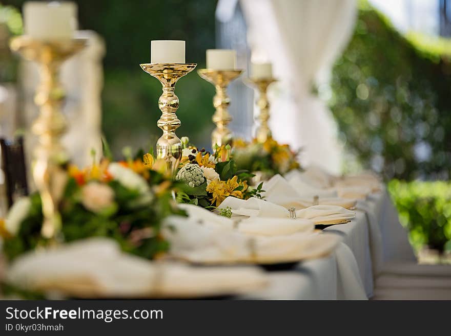 Four White Tealight Candles on Brass-colored Candlesticks