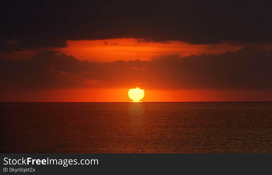 Silhouette of Clouds during Golden Hour Photograph