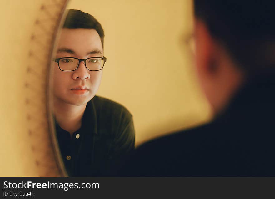 Photo of Man Looking at the Mirror