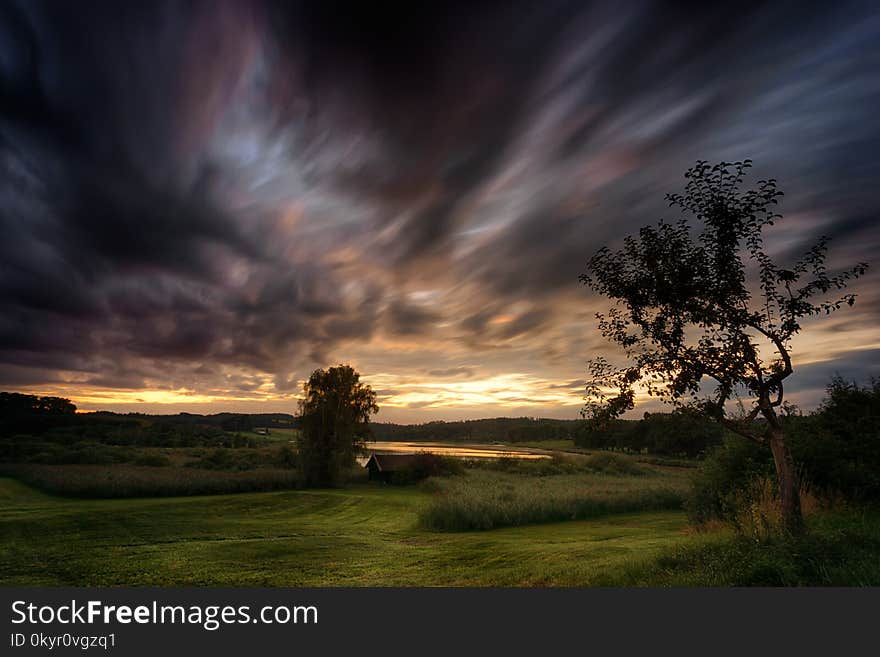 Green Grass Field With Dark Sky