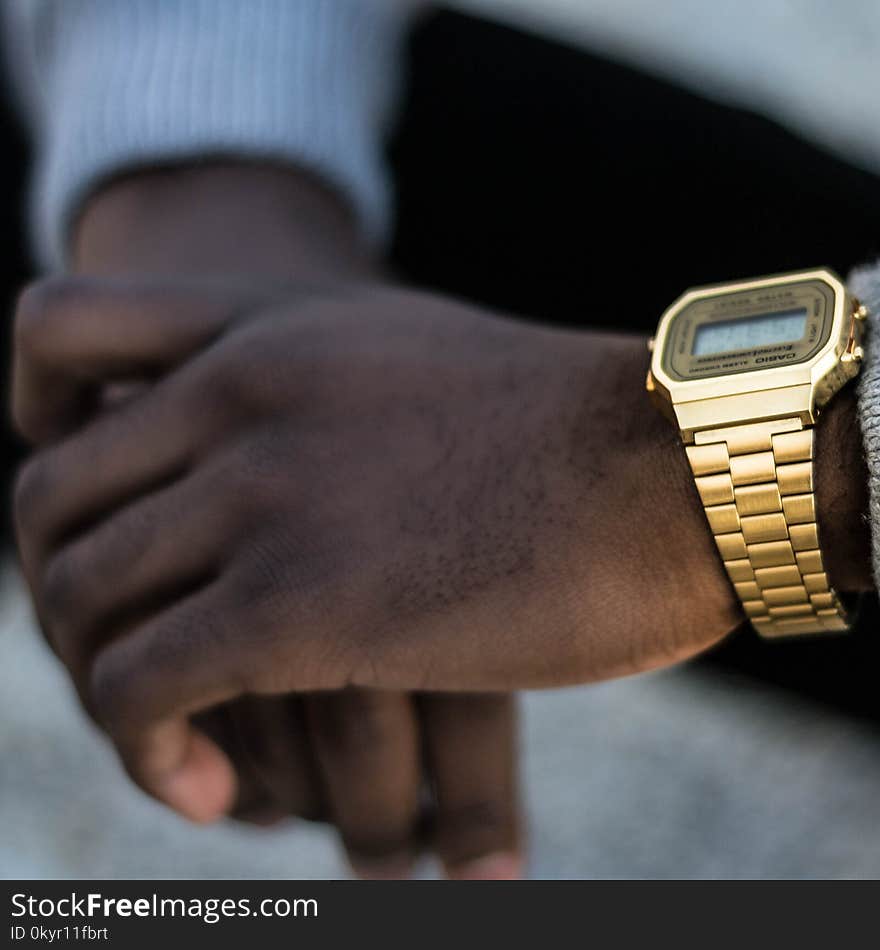 Person Wearing Gold-colored Casio Digital Watch With Linked Strap