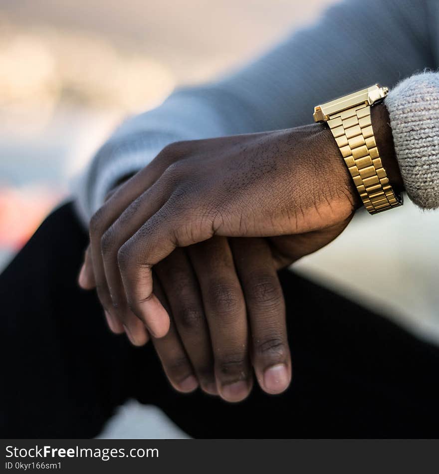 Man Wearing Gold-colored Wristwatch