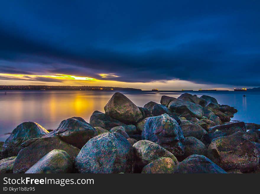 Body Of Water Under Cloudy Sky