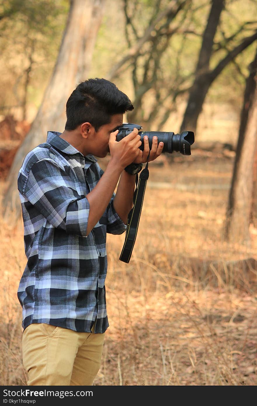 Man Holding Black Dslr Camera