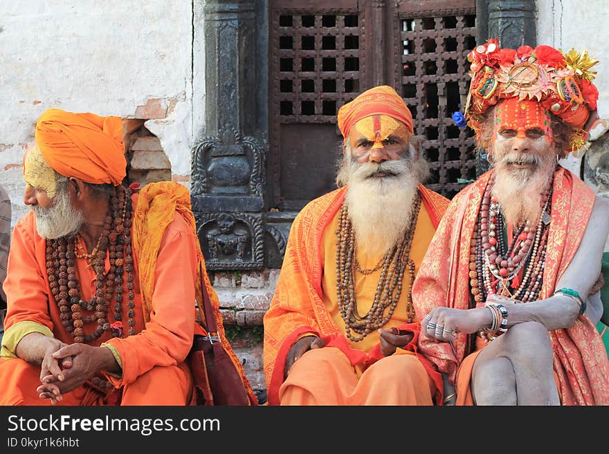 Three Men Wearing Orange Tradition Clothes