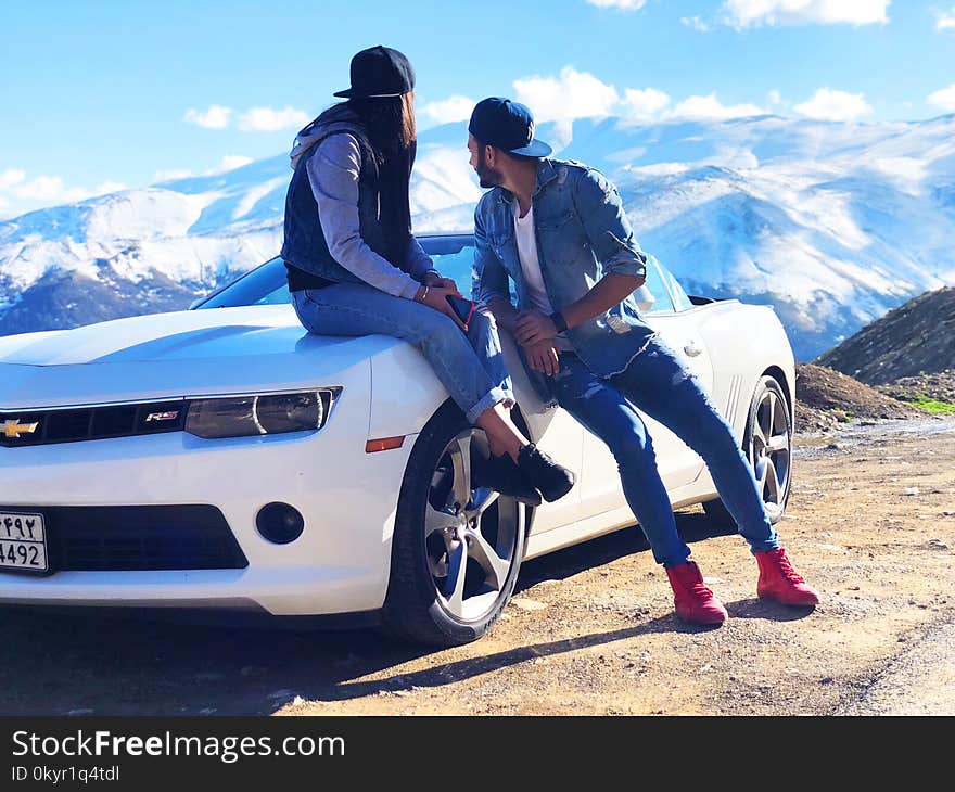 Couple Near White Chevrolet Coupe