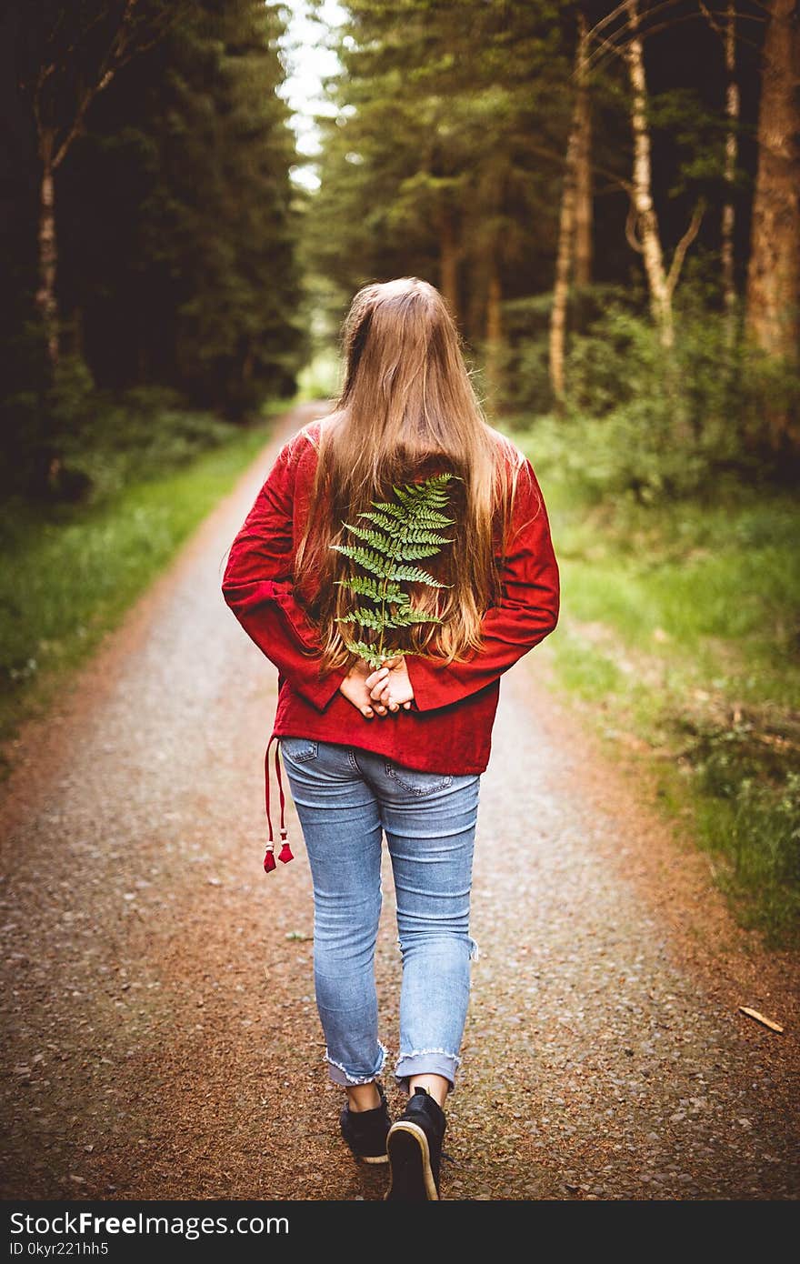 Woman Holding Leaves on Her Back