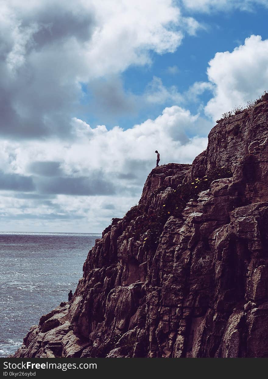 Person Standing On Cliff