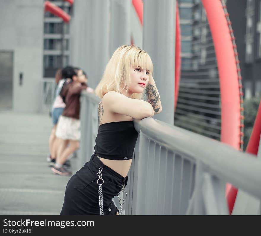 Photo of Woman Leaning On Railing