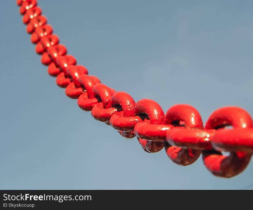 Red chain link into the sky. Selective focus.