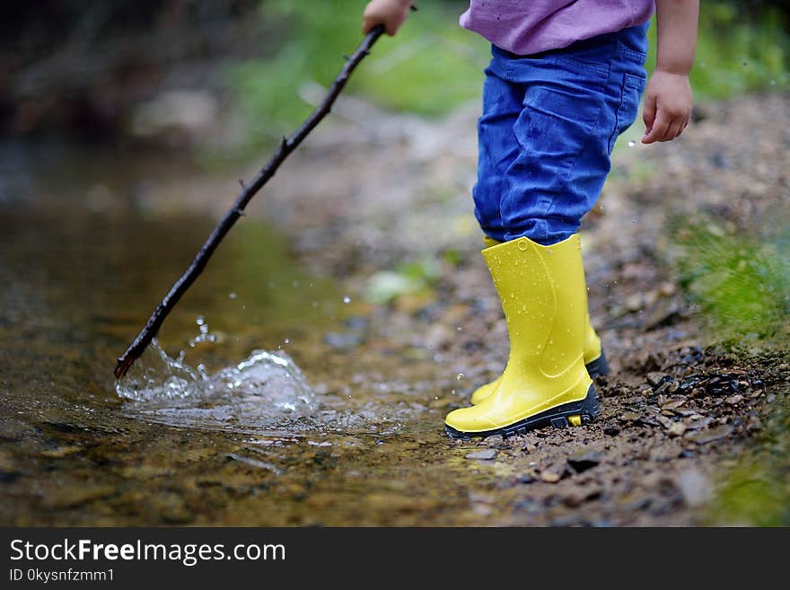 Two pairs of color children`s gumboots standing children. Walk in color rubber children`s boots