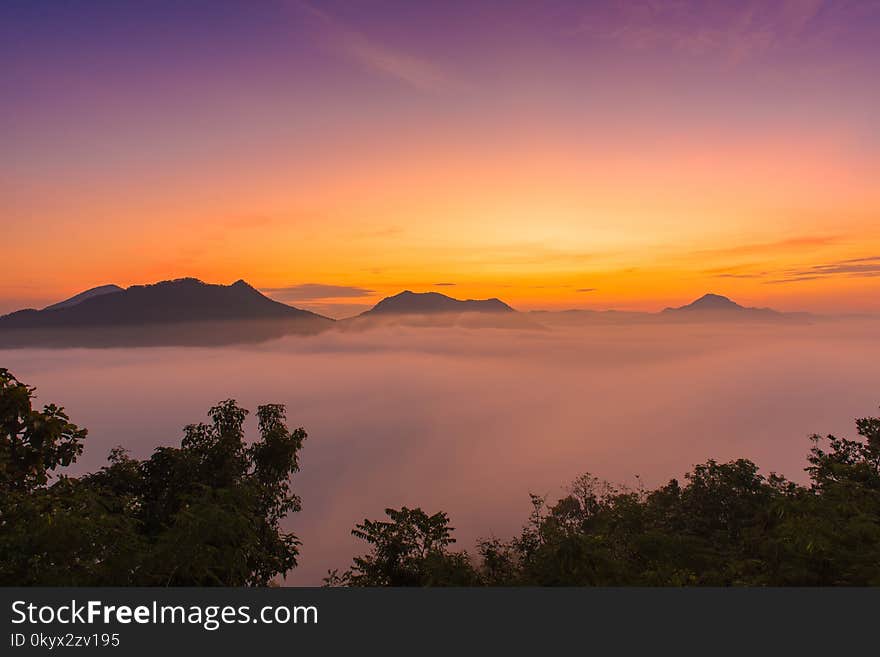 mountains under mist in the morning with sunrise at Phutoke Loei Thailand