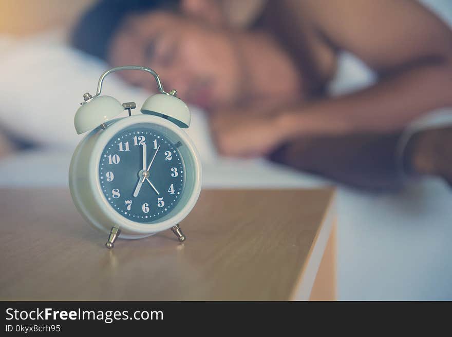 alarm clock on the bed in bedroom