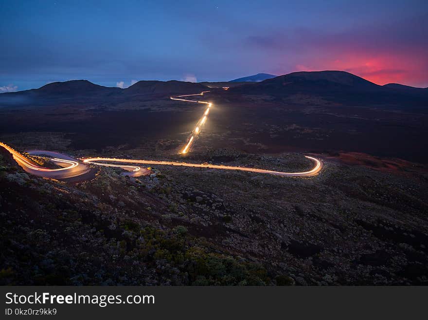 Light trails of cars during The Piton de la Fournaise volcano eruption at La Plaine des Sables in Reunion Island. Light trails of cars during The Piton de la Fournaise volcano eruption at La Plaine des Sables in Reunion Island