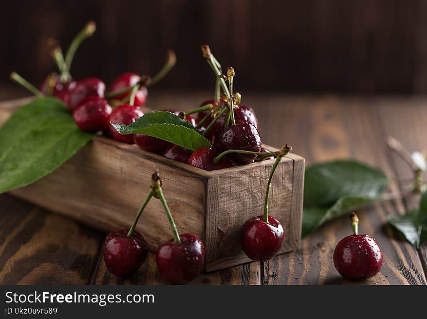 Fresh cherry with water drops on rustic wooden background. Fresh cherries background. Healthy food concept