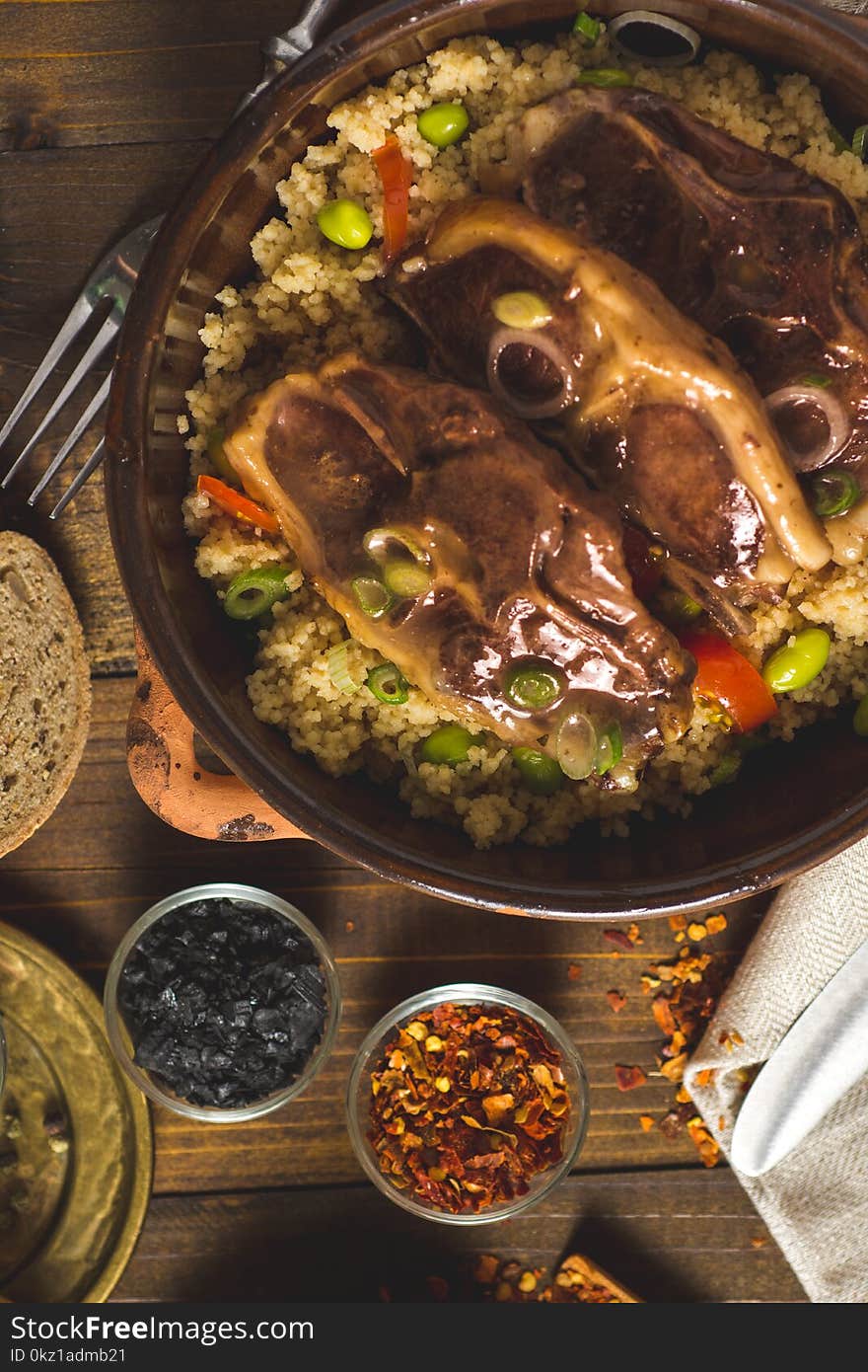 Roasted Lamb Loin Chops with Couscous and Soybean in Rustic Clay Dish