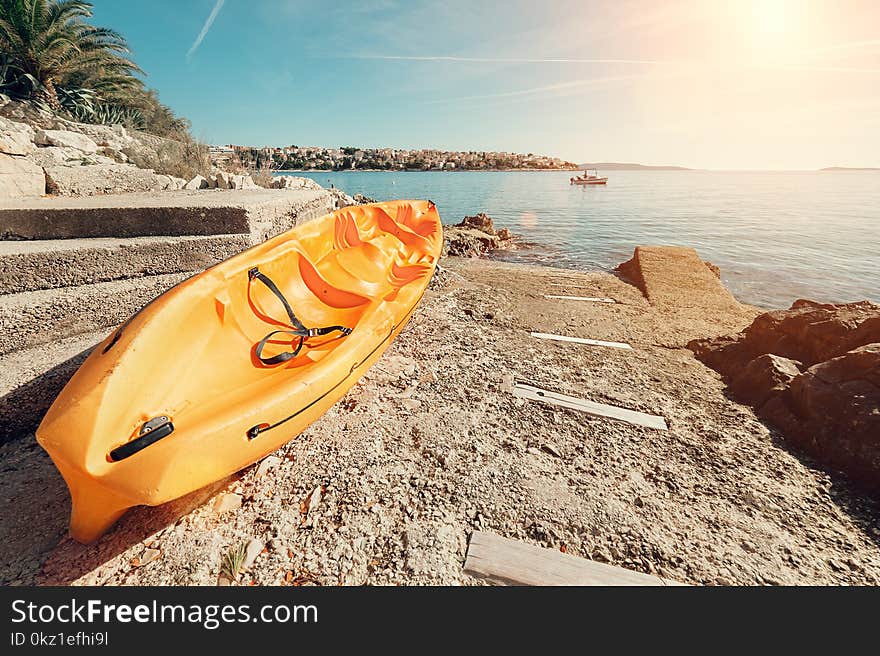 Bright Orange Kayak Is On The Stone Sea Pier