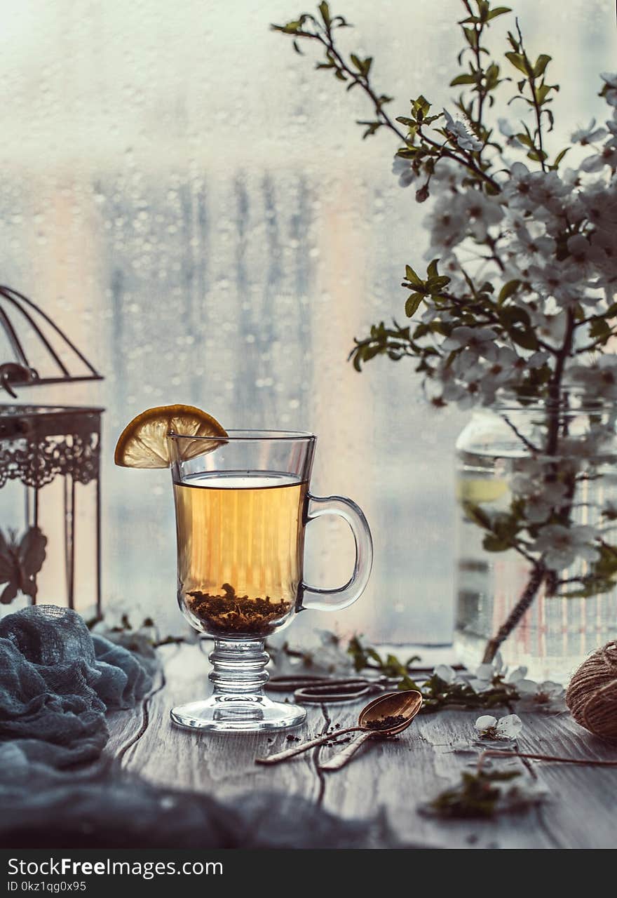 Fresh green tea. Tea cup with green tea leaf on the wooden table. Tea with lemon.