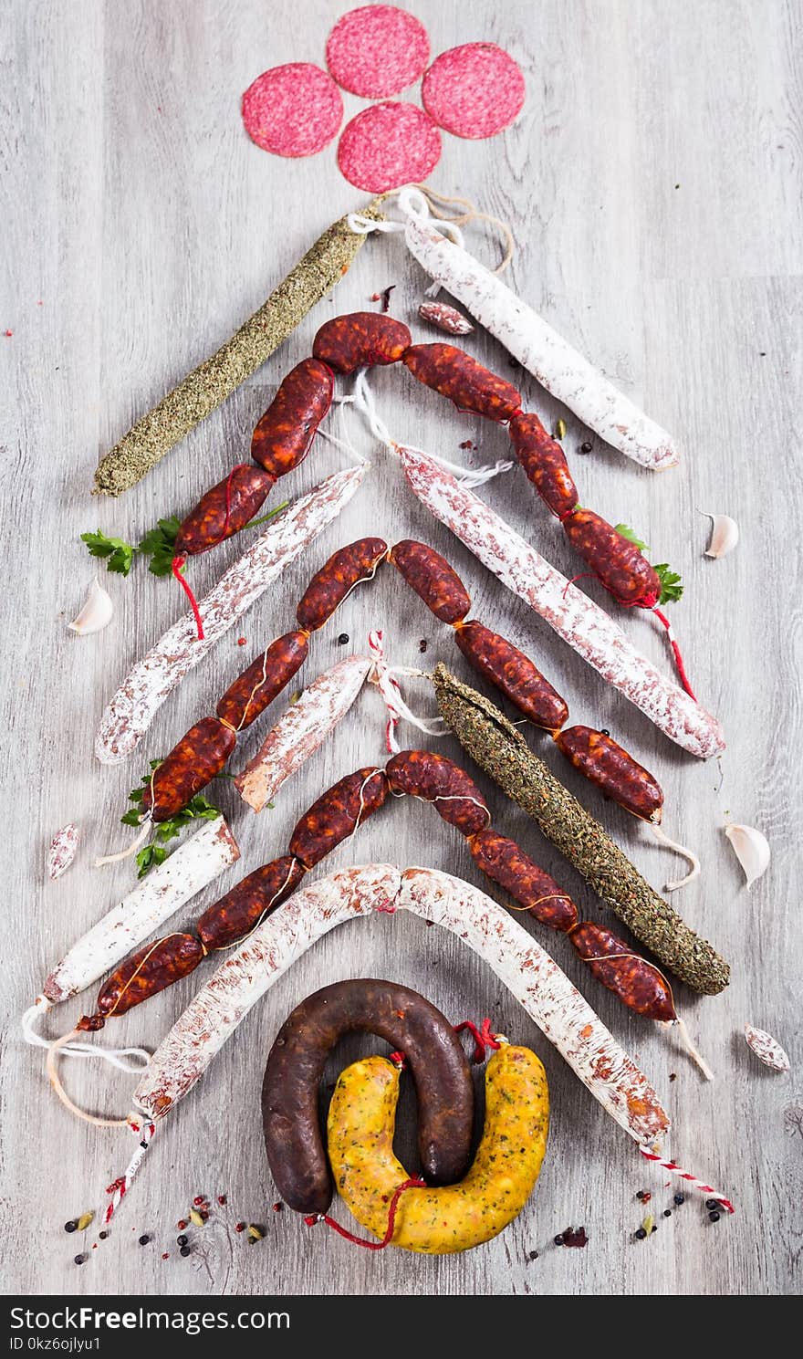 Christmas tree made of sausage on a background of a wooden wall