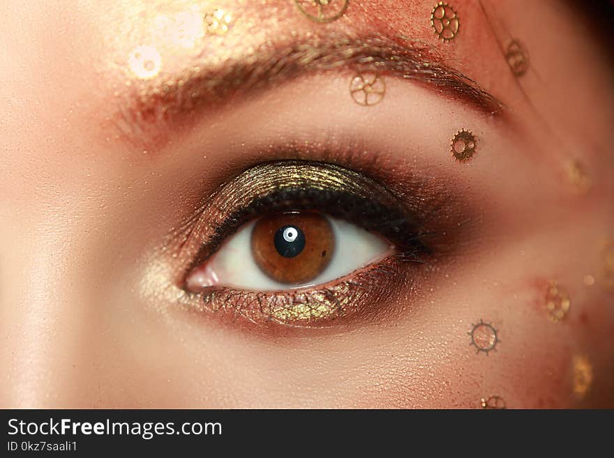 Beautiful woman eye with steampunk make-up close up macro